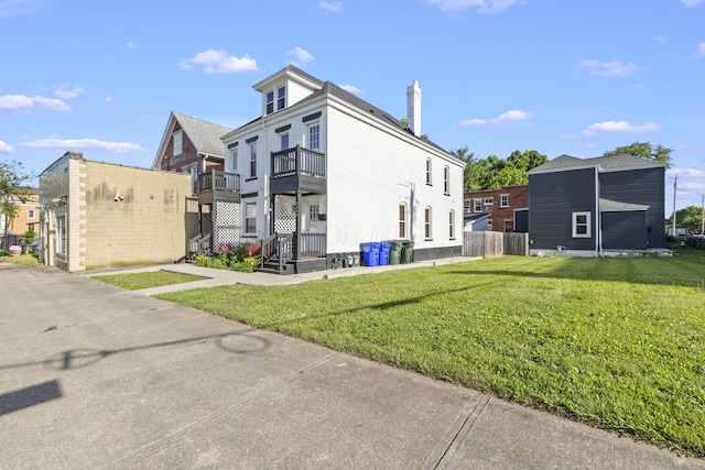 view of property exterior featuring a yard and a balcony