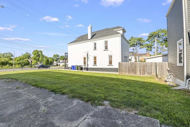 back of property featuring a yard