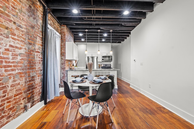 dining area with light wood-type flooring and brick wall