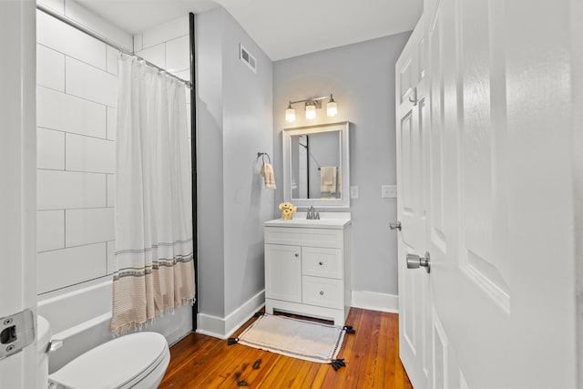 full bathroom with vanity, wood-type flooring, toilet, and shower / bath combo with shower curtain