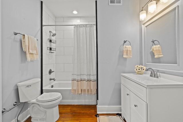 full bathroom with vanity, toilet, hardwood / wood-style floors, and shower / bath combo with shower curtain