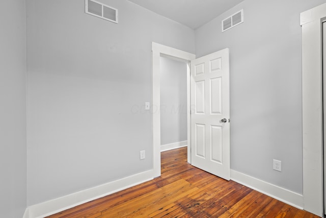 empty room with hardwood / wood-style floors