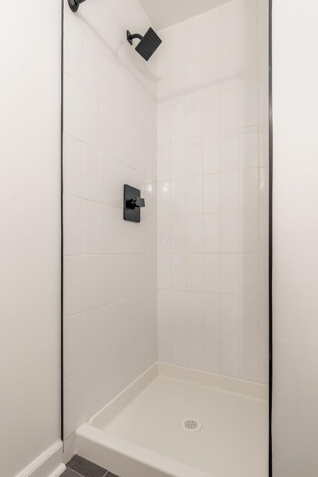 bathroom with tiled shower