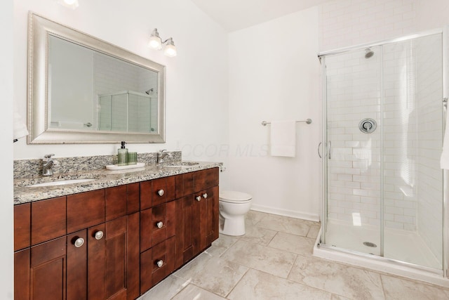 bathroom featuring vanity, toilet, and a shower with shower door