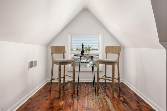 interior space featuring lofted ceiling and dark hardwood / wood-style floors