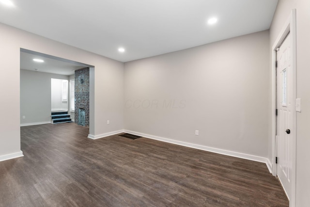 unfurnished room with dark hardwood / wood-style floors