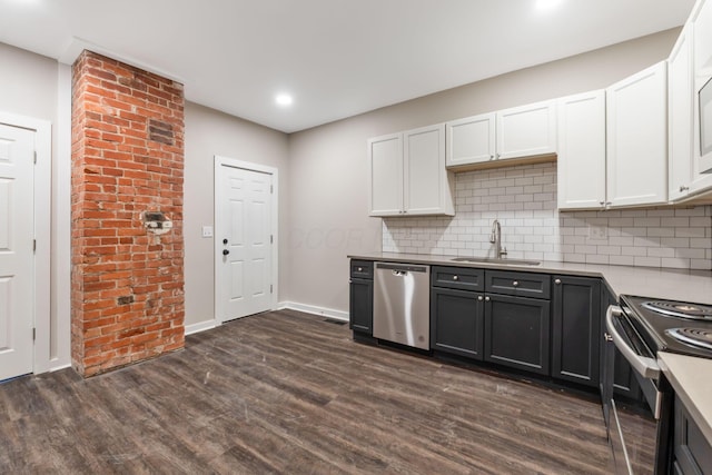 kitchen featuring appliances with stainless steel finishes, dark hardwood / wood-style floors, white cabinetry, sink, and backsplash