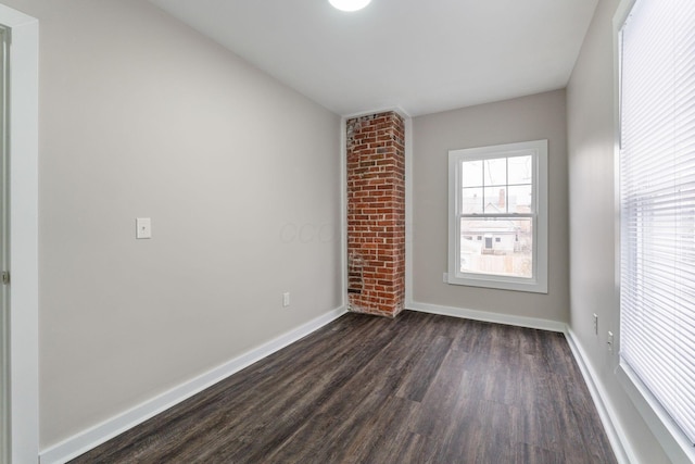 spare room with dark hardwood / wood-style floors