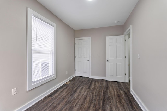 unfurnished bedroom featuring dark hardwood / wood-style floors