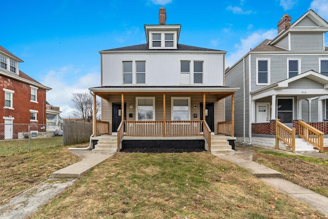 view of front of property with a front yard and covered porch