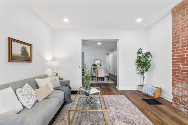 living room featuring dark wood-type flooring