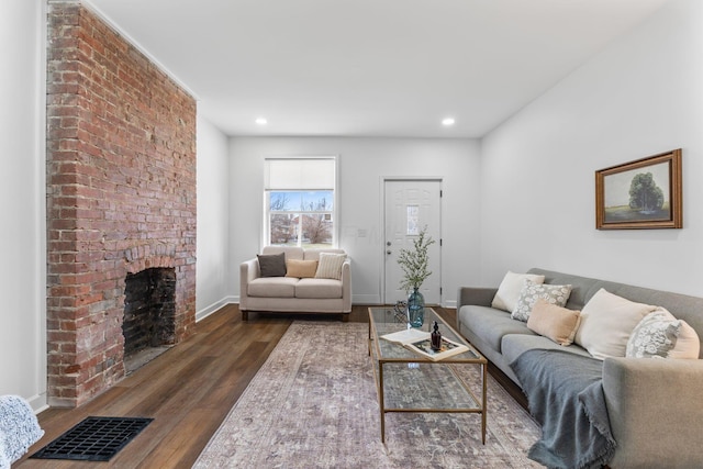 living room with a fireplace and dark hardwood / wood-style floors