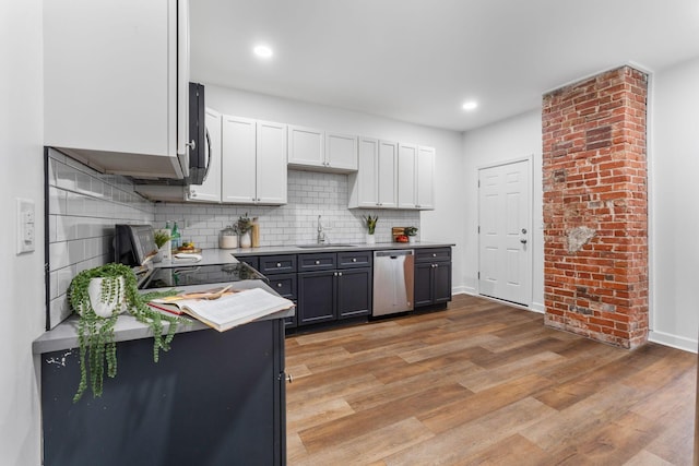 kitchen with sink, dishwasher, white cabinetry, tasteful backsplash, and light wood-type flooring