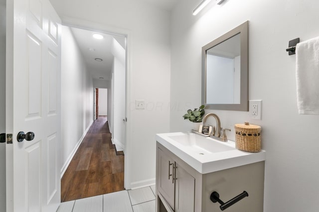 bathroom featuring hardwood / wood-style flooring and vanity