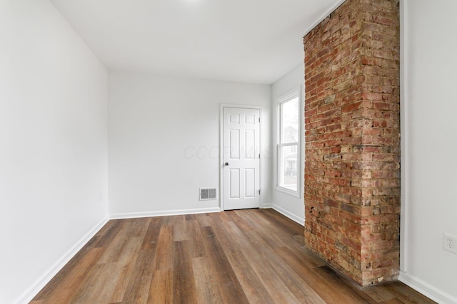 unfurnished room with hardwood / wood-style flooring