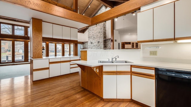 kitchen featuring beamed ceiling, dishwasher, sink, and white cabinets