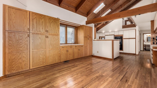 kitchen with hardwood / wood-style floors, high vaulted ceiling, black double oven, wooden ceiling, and beamed ceiling