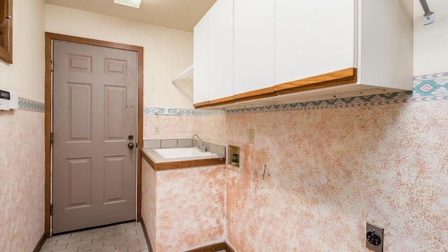 clothes washing area with cabinets, washer hookup, sink, and electric dryer hookup