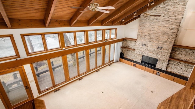 carpeted living room featuring a stone fireplace, wood ceiling, high vaulted ceiling, ceiling fan, and beam ceiling