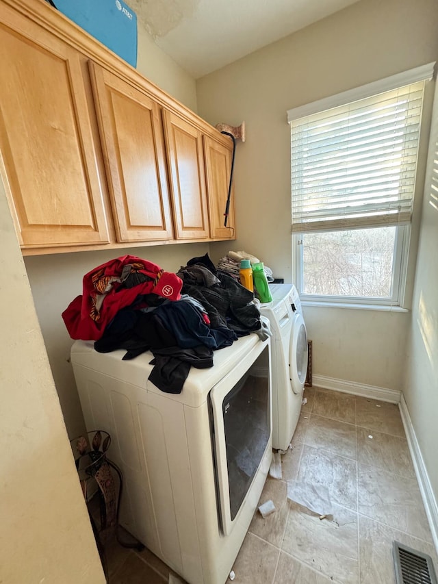 laundry room featuring cabinets and washing machine and clothes dryer