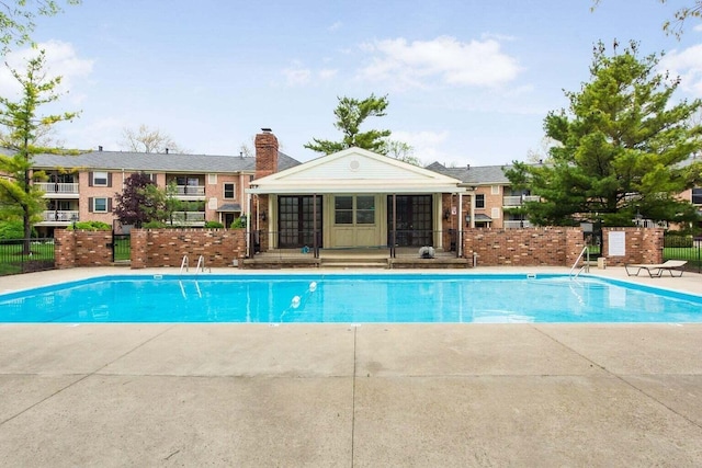 view of pool with an outbuilding