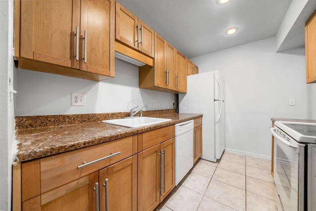 kitchen with white appliances, light tile patterned flooring, sink, and dark stone countertops