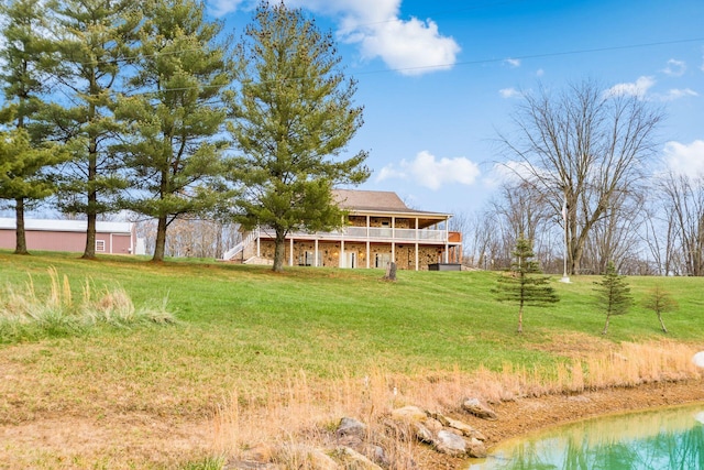 view of yard featuring a deck with water view