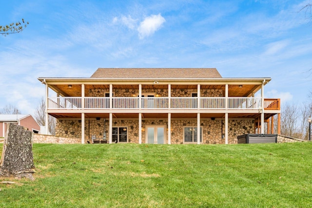 back of property with a wooden deck and a lawn