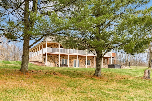 back of property with a lawn and a deck