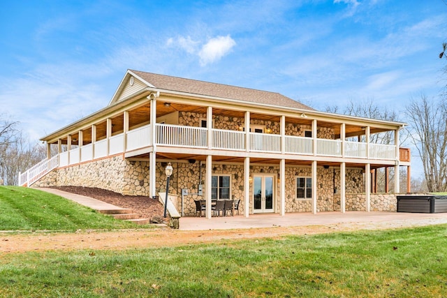 back of house featuring a patio area, french doors, and a lawn