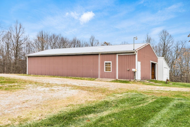 view of outbuilding featuring a lawn