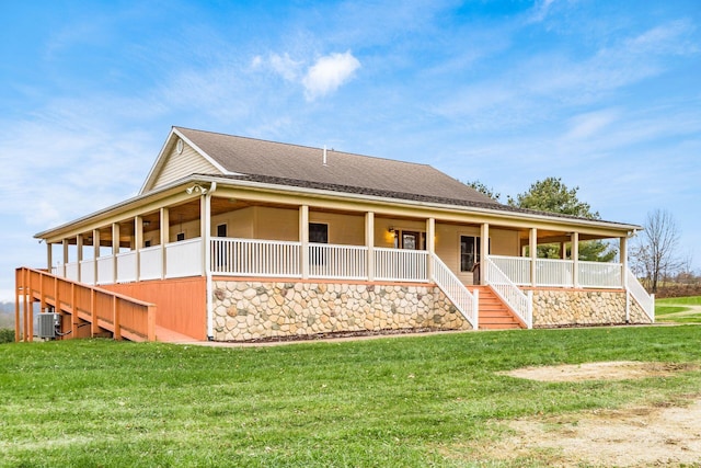 rear view of property featuring central AC unit and a lawn