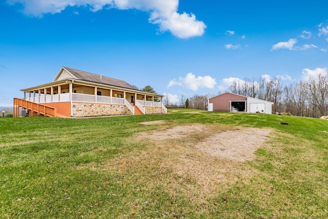 exterior space featuring a porch, an outbuilding, cooling unit, and a lawn