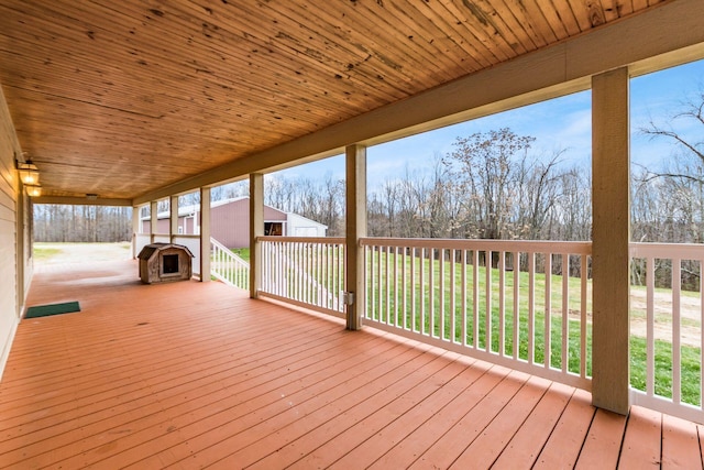 wooden terrace featuring an outdoor fireplace