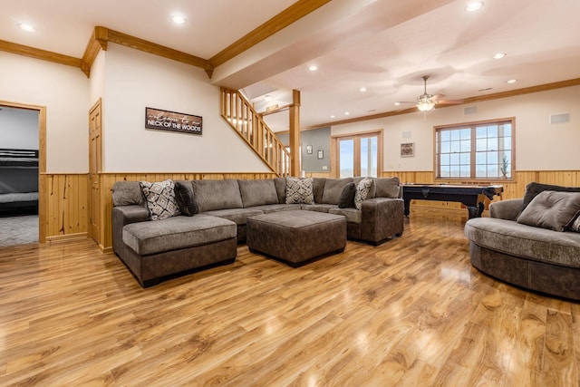 living room featuring crown molding and light hardwood / wood-style floors