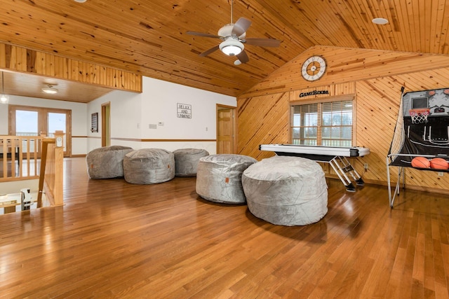 sitting room with hardwood / wood-style flooring, wooden walls, vaulted ceiling, and wooden ceiling