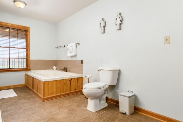 bathroom featuring a tub and toilet