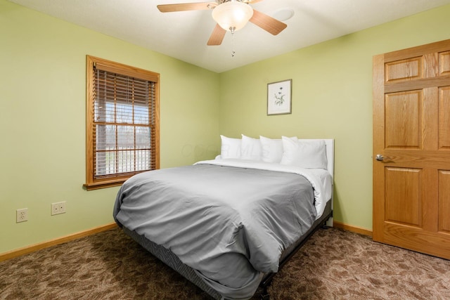 bedroom featuring ceiling fan and dark carpet