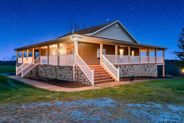 back of property with a yard and a porch