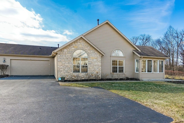 view of front of property with a garage and a front lawn