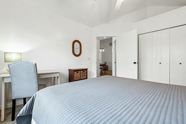 bedroom featuring ceiling fan, lofted ceiling, hardwood / wood-style floors, and a closet