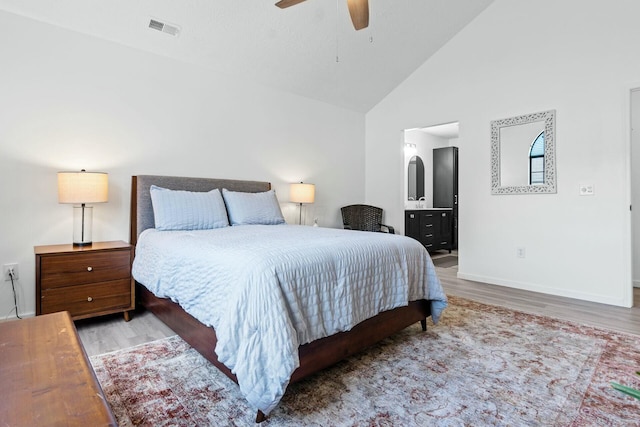 bedroom featuring ensuite bathroom, high vaulted ceiling, ceiling fan, and light hardwood / wood-style floors