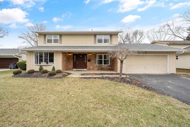 view of property with a garage and a front lawn