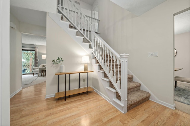 staircase featuring hardwood / wood-style flooring