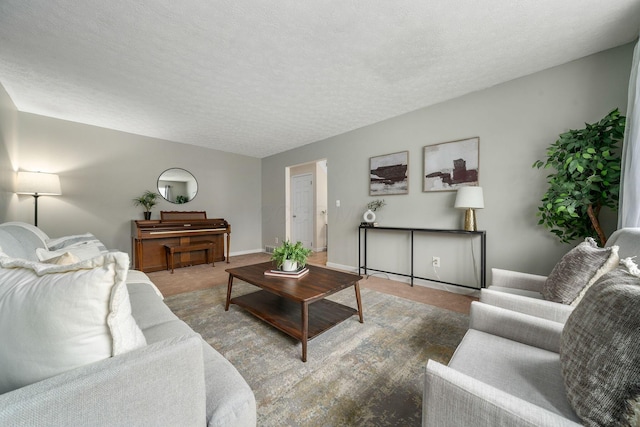 living room featuring light colored carpet and a textured ceiling