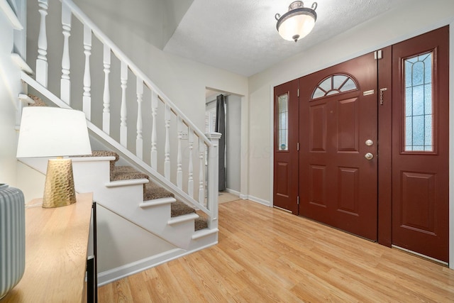 entryway featuring hardwood / wood-style flooring and a textured ceiling