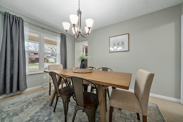 dining area featuring a notable chandelier and carpet