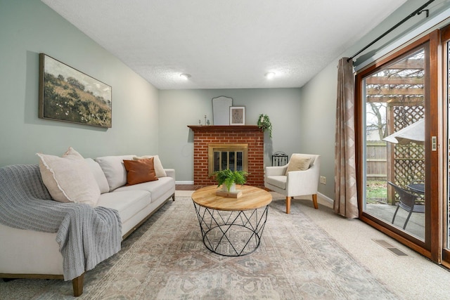 carpeted living room with a brick fireplace