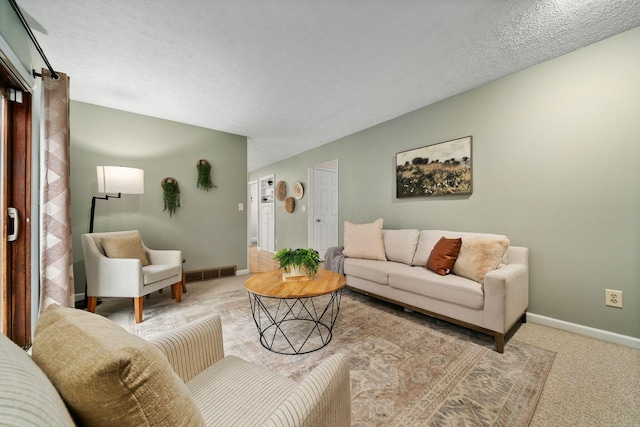 living room with light carpet and a textured ceiling