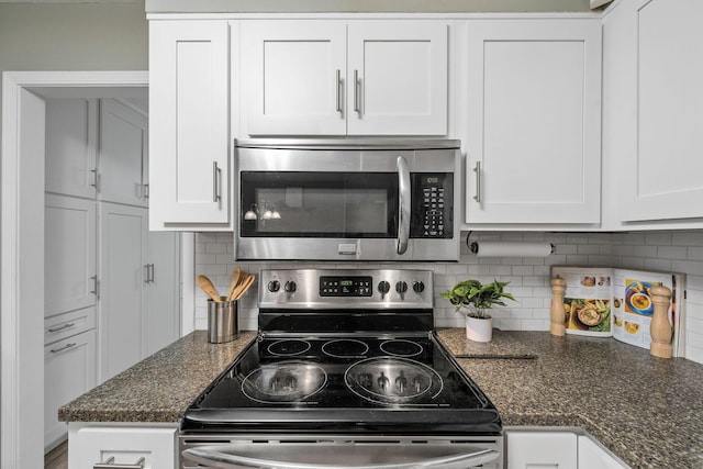 kitchen featuring tasteful backsplash, appliances with stainless steel finishes, dark stone counters, and white cabinets